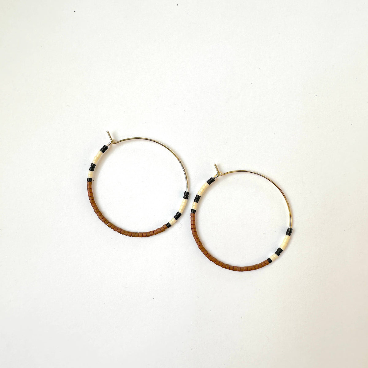 Pair of hoop earrings with beaded accents on a white background