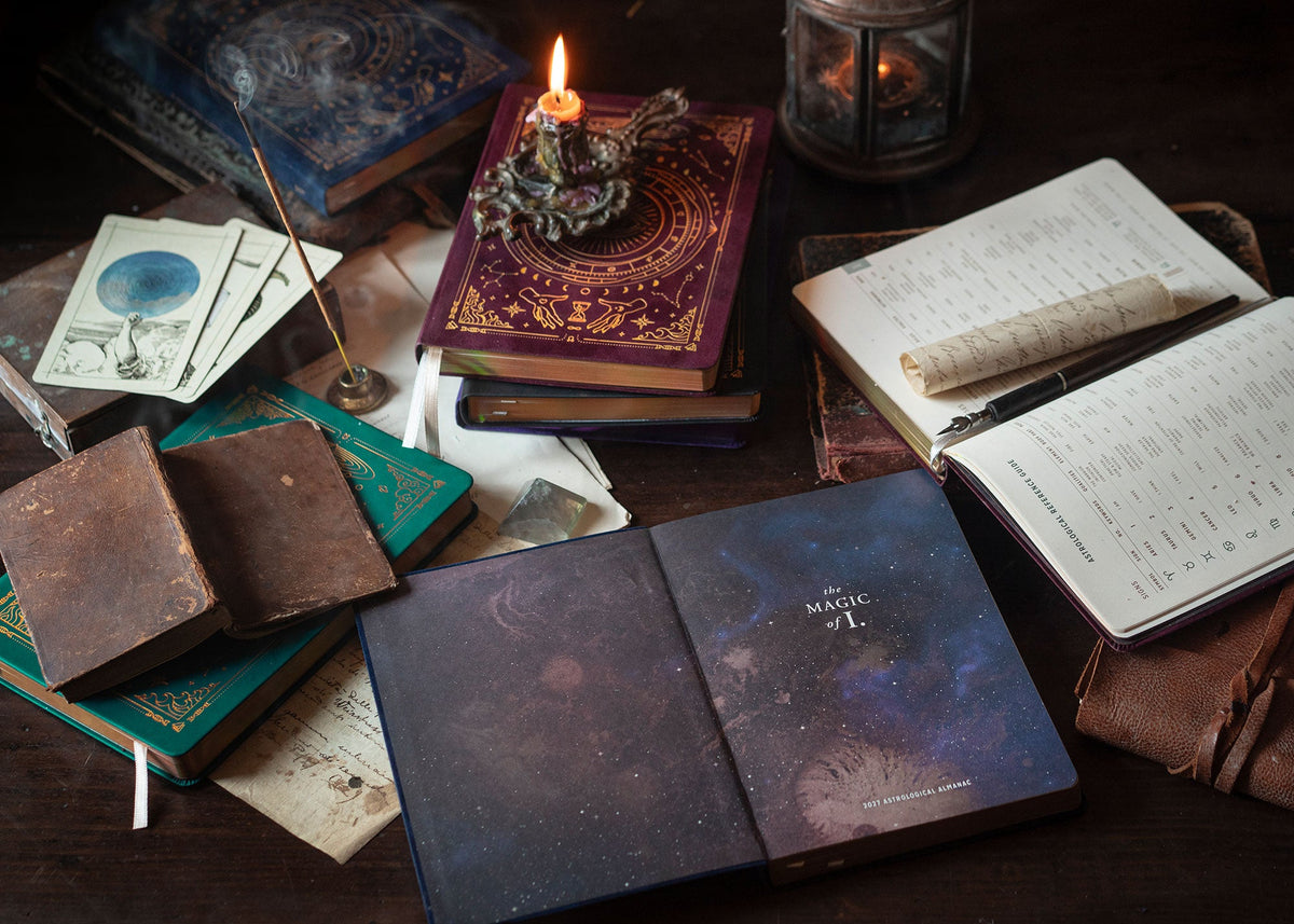 2027 Astrological Almanac by Magic of I in pomegranate with gold foil eye and ouroboros design